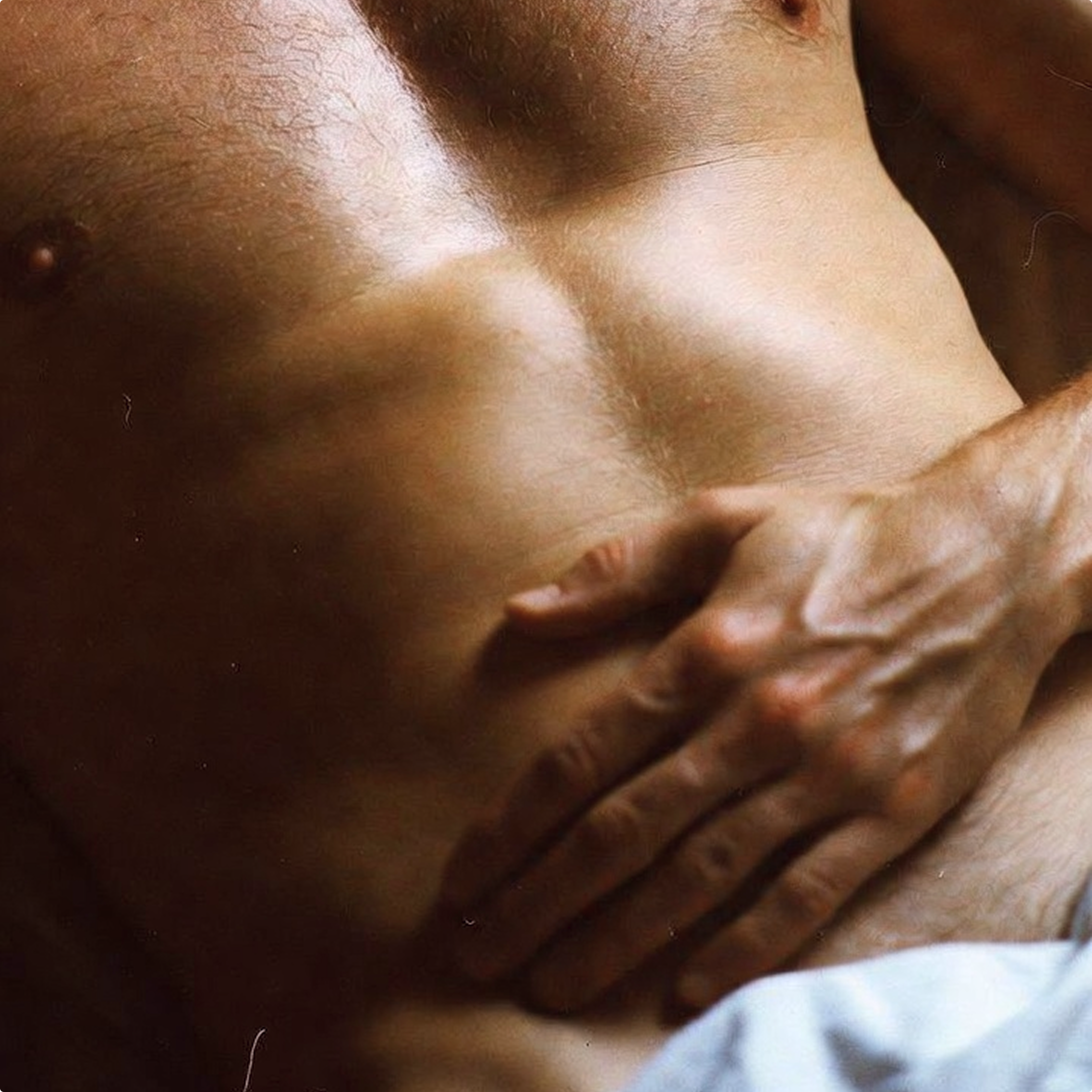 Close-up of a person's torso with a hand on their chest